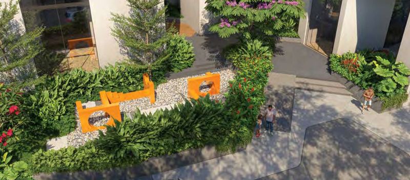 The interactive kids play area at Myscape Palma with orange play structures set among dense tropical planting