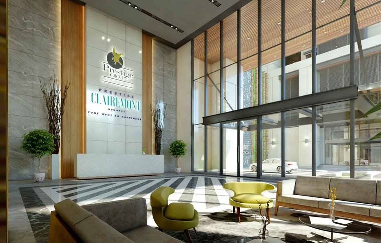 Double-height entrance lobby interior at Prestige Clairemont with reception desk